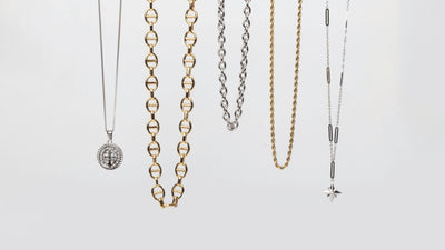 Necklaces from the MARRIN COSTELLO jewelry collection, hanging as if being worn, to showcase the different styles of necklaces. Available in both 14k gold plated stainless steel and polished stainless steel.