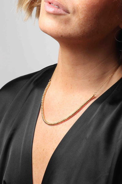 Marrin Costello wearing Marrin Costello Jewelry Crown Chain dainty dot necklace with lobster clasp closure and extender. Waterproof, sustainable, hypoallergenic. 14k gold plated stainless steel.