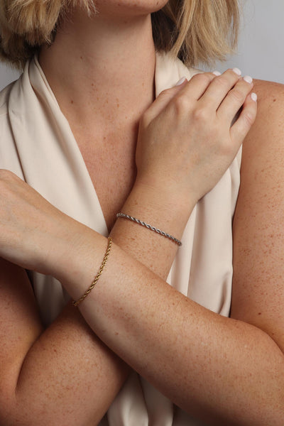 Marrin Costello wearing Marrin Costello Jewelry Helix 3mm rope twist chain bracelet with lobster clasp closure. Waterproof, sustainable, hypoallergenic. 14k gold plated and polished stainless steel.