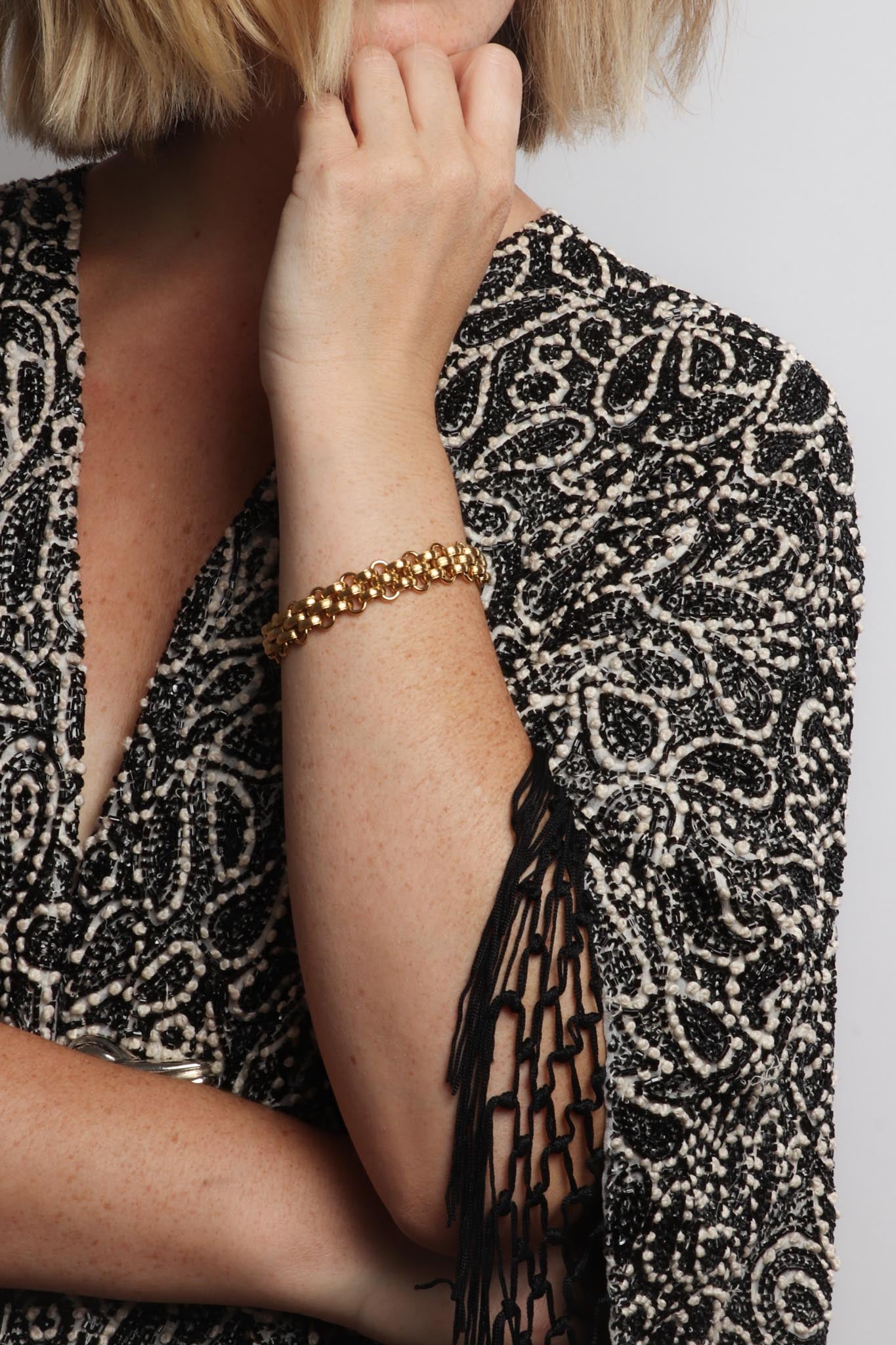 Marrin Costello wearing Marrin Costello Jewelry Lattice XL Bracelet woven chain bracelet with lobster clasp closure. Waterproof, sustainable, hypoallergenic. 14k gold plated stainless steel.