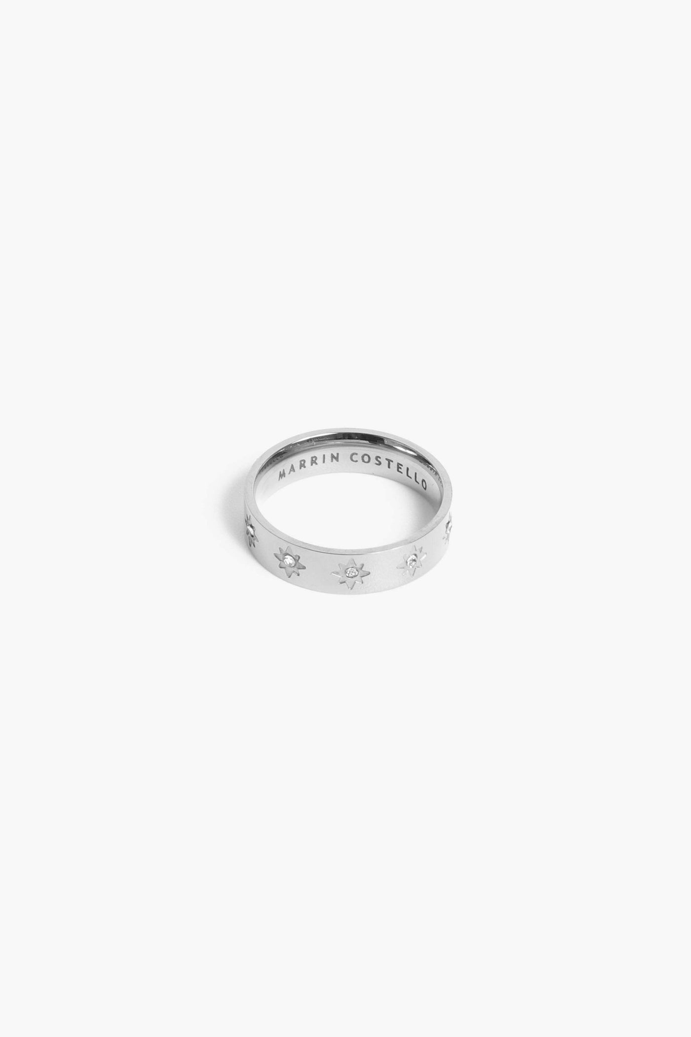 Marrin Costello Jewelry Orion Band star motif ring with CZ detail. Available in sizes 6, 7, 8. Waterproof, sustainable, hypoallergenic. Polished stainless steel.