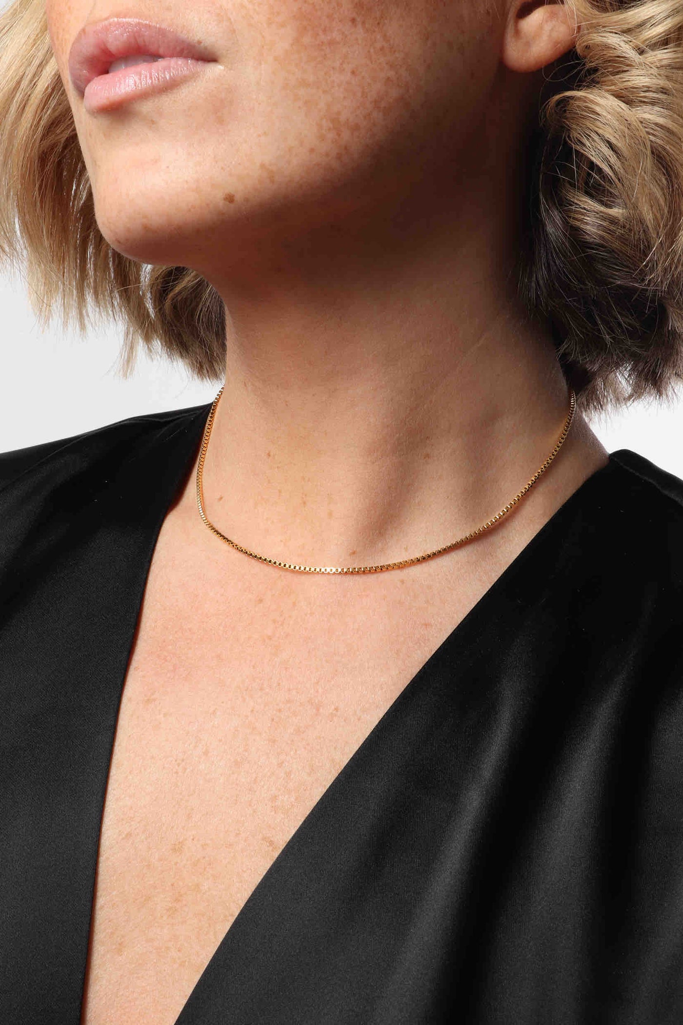 Marrin Costello wearing Marrin Costello Jewelry Nile Choker delicate dainty box link chain with lobster clasp closure and extender. Waterproof, sustainable, hypoallergenic. 14k gold plated stainless steel.