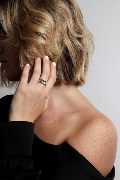 Marrin Costello wearing Marrin Costello Jewelry Queens Band cuban link statement ring. Available in sizes 6, 7, 8. Waterproof, sustainable, hypoallergenic. Polished stainless steel.