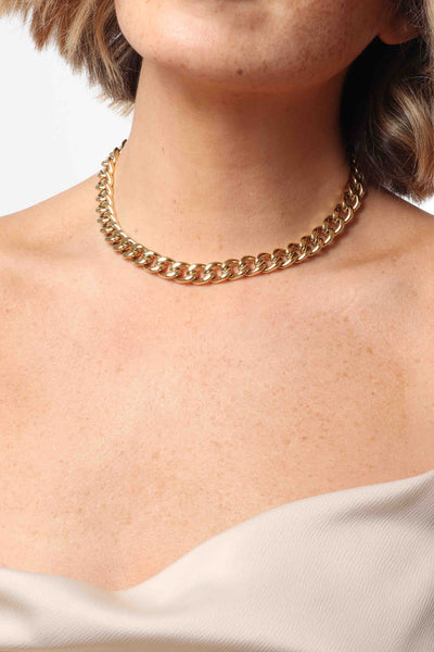 Marrin Costello wearing Marrin Costello Jewelry Queens Choker chunky statement cuban link chain necklace with lobster clasp closure and extender. Waterproof, sustainable, hypoallergenic. 14k gold plated stainless steel.
