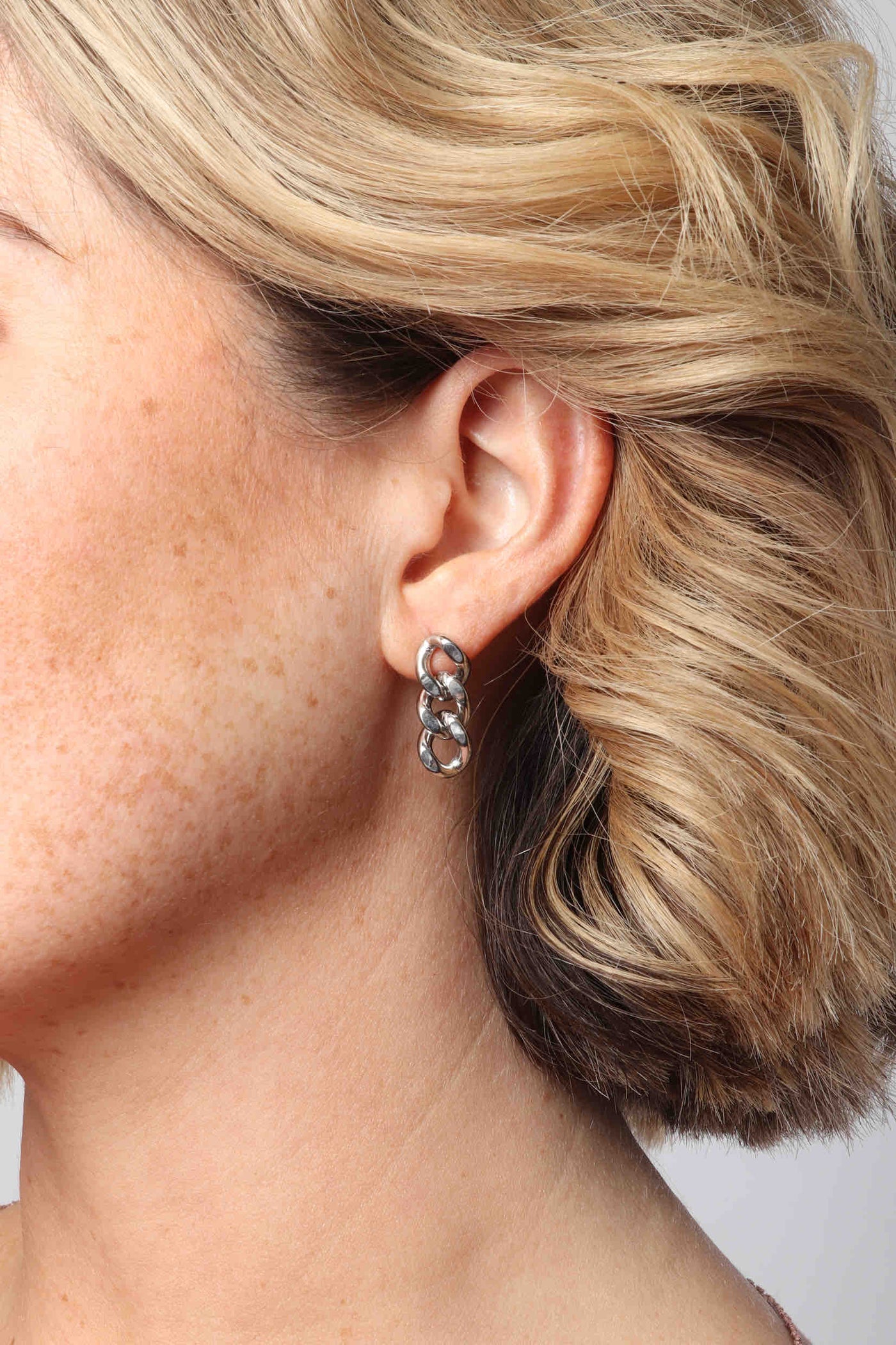 Marrin Costello wearing Marrin Costello Jewelry Queens Drops cuban link post back earrings — for pierced ears. Waterproof, sustainable, hypoallergenic. Polished stainless steel.