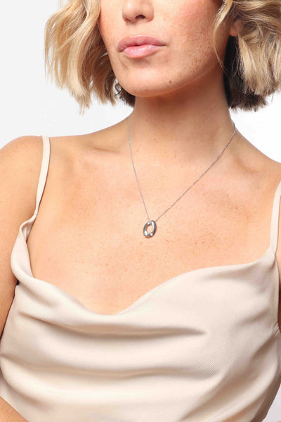 Marrin Costello wearing Marrin Costello Jewelry Queens Pendant necklace with single cuban link chain link with lobster clasp closure and extender. Waterproof, sustainable, hypoallergenic. Polished stainless steel.