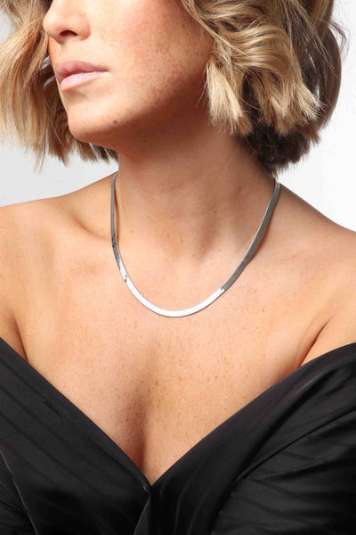 Marrin Costello wearing Marrin Costello Jewelry Ramsey Chain 5mm thick snake herringbone chain with lobster clasp closure and extender. Waterproof, sustainable, hypoallergenic. Polished stainless steel.