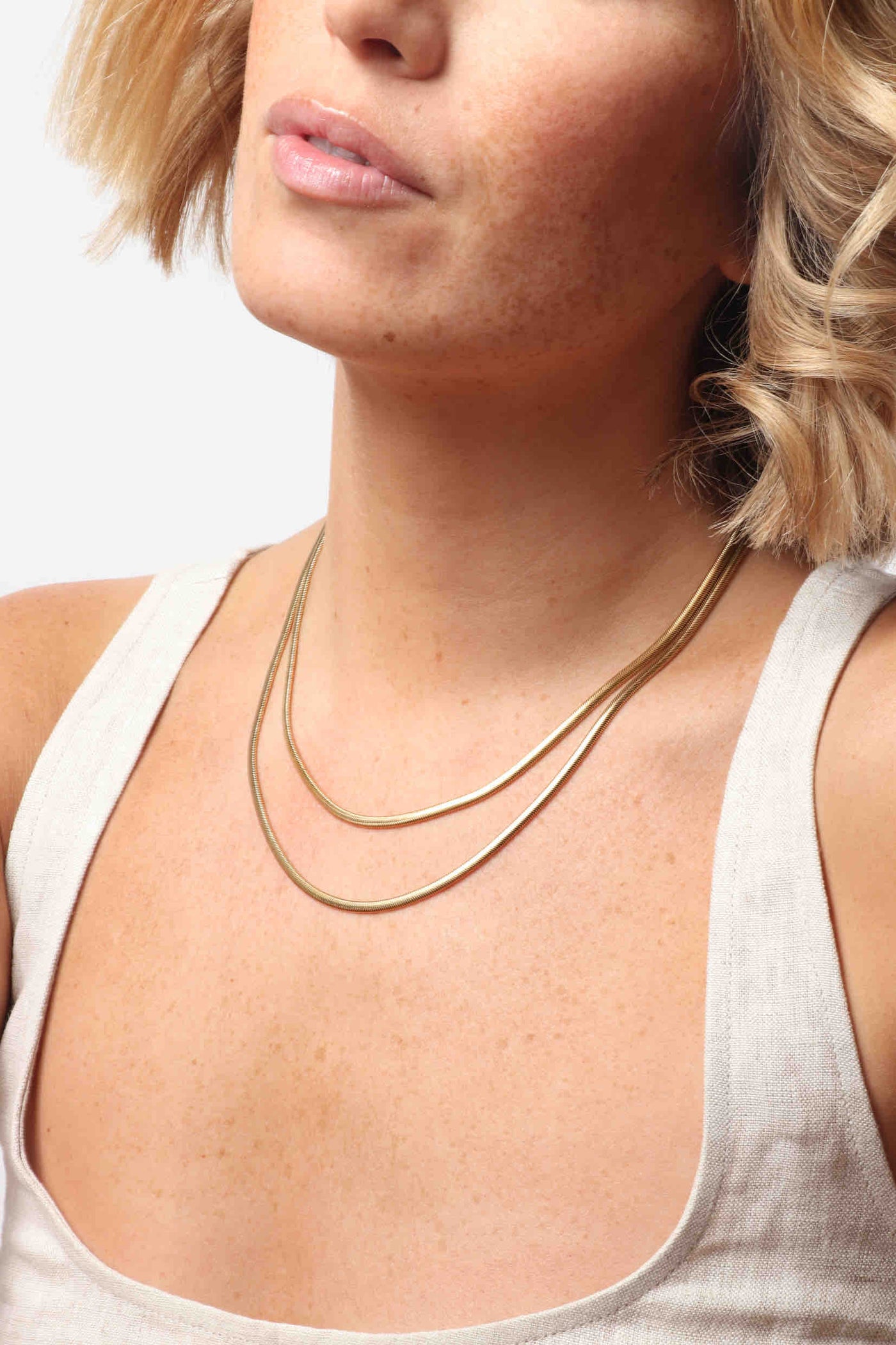 Marrin Costello wearing Marrin Costello Jewelry Ramsey Layers snake herringbone chain layered together 2 in 1 necklace with lobster clasp closure and extender. Waterproof, sustainable, hypoallergenic. 14k gold plated stainless steel.